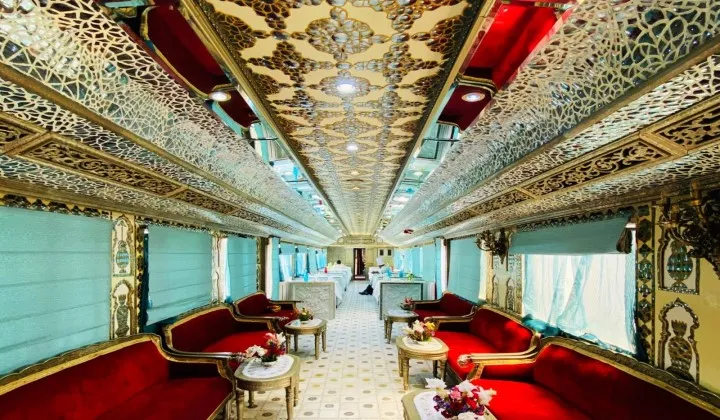 Palace on Wheels dining car interior ornate red sofas luxury India train tour TTI Tours